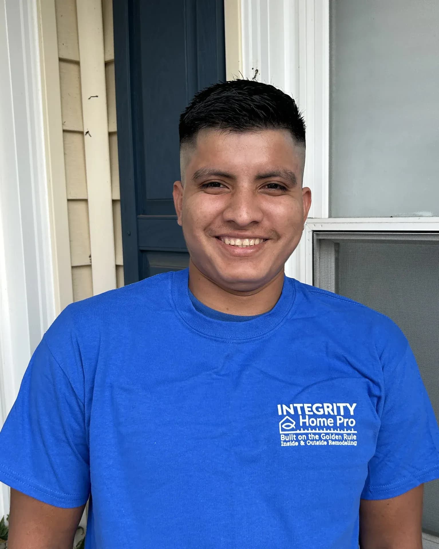 A headshot of a team member in a blue Integrity Home Pro t-shirt.