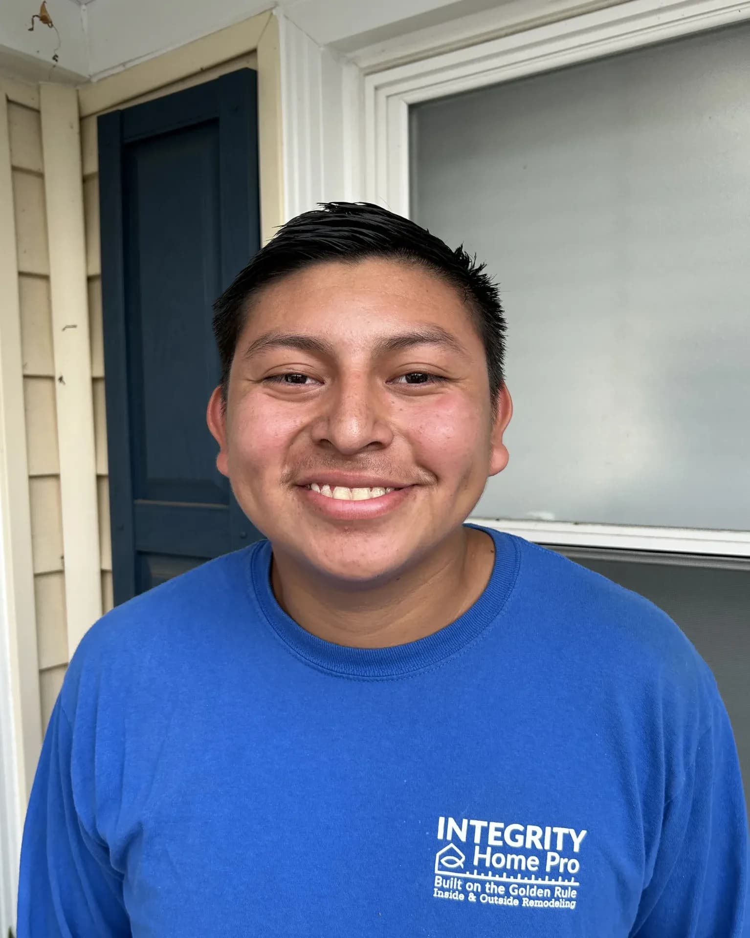A headshot of a team member in a blue Integrity Home Pro t-shirt.