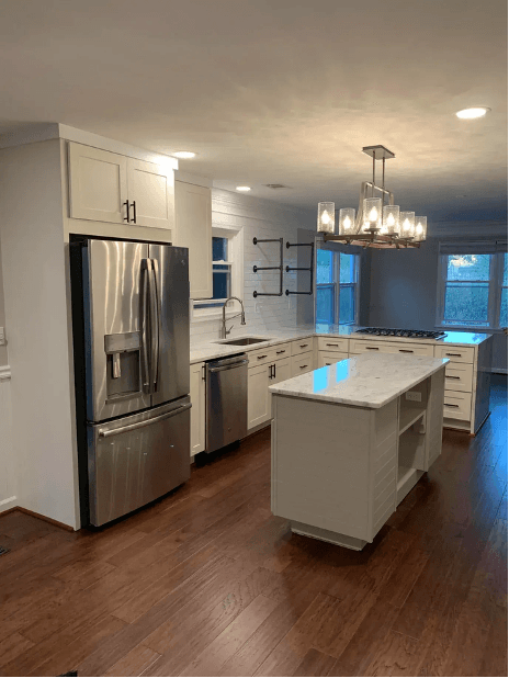 A charming traditional-style kitchen with wooden cabinets, classic appliances, and warm lighting. The rustic details and vintage decor create a comfortable and welcoming atmosphere with a timeless feel.