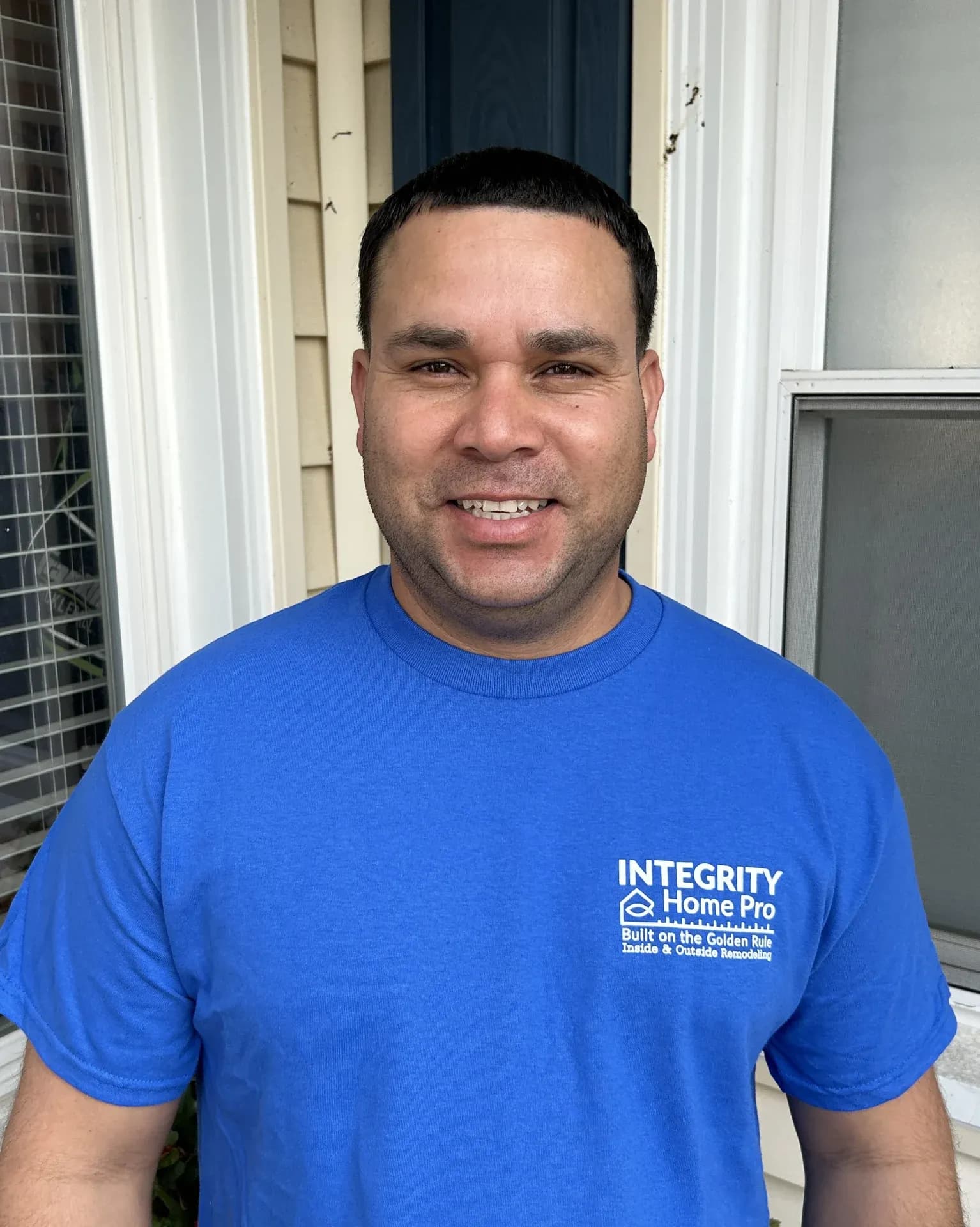 A headshot of a team member in a blue Integrity Home Pro t-shirt.