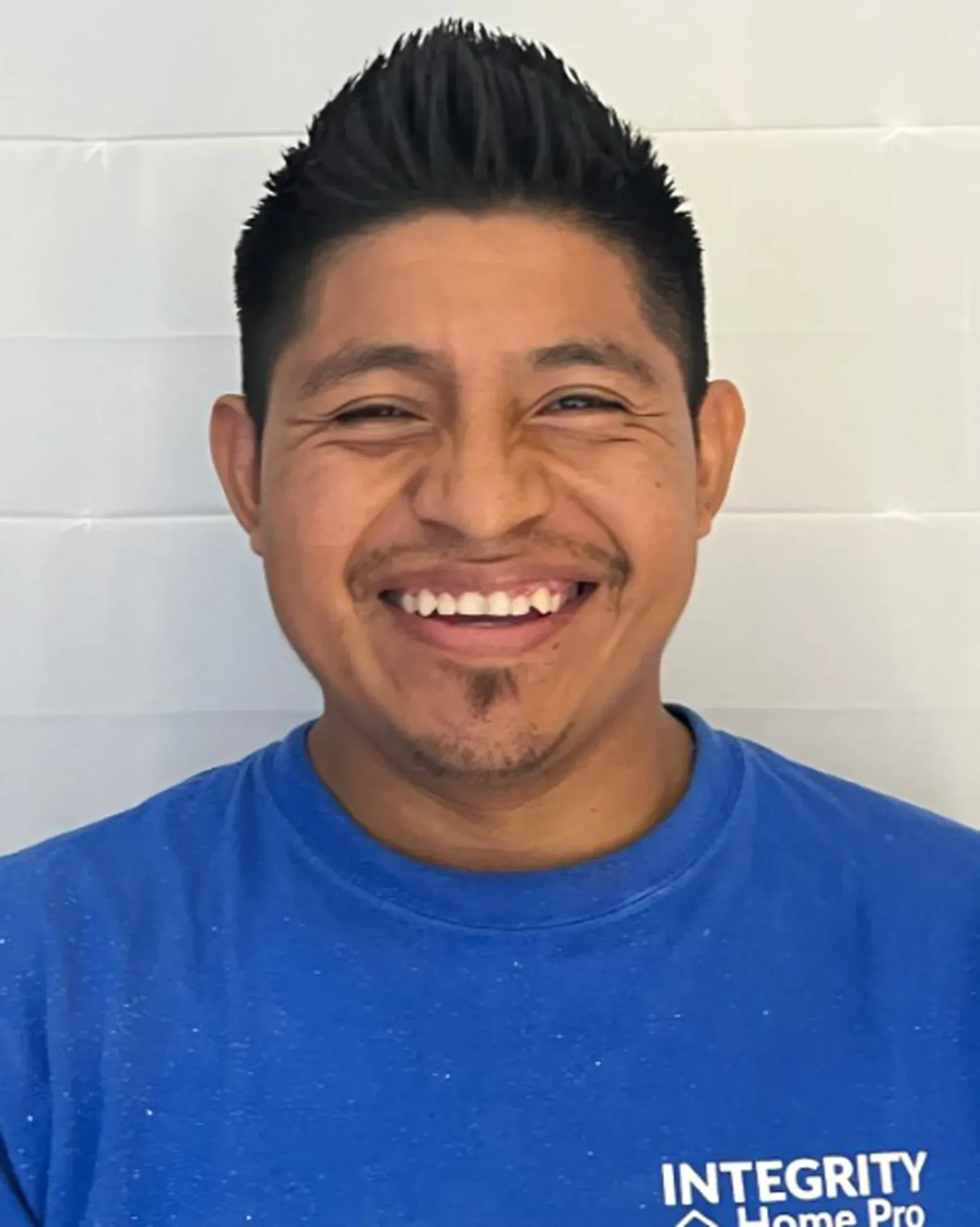 A headshot of a team member in a blue Integrity Home Pro t-shirt.