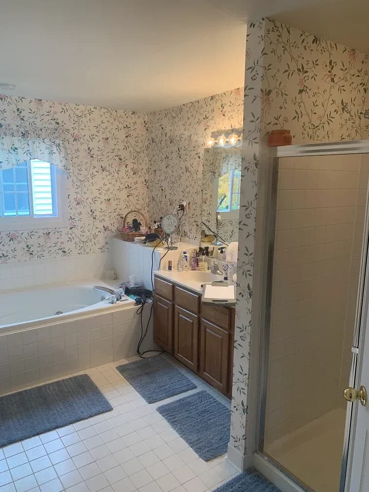 A photo of a jacuzzi-style tub, bathroom vanity with brown cabinets, and a shower with a shower door.