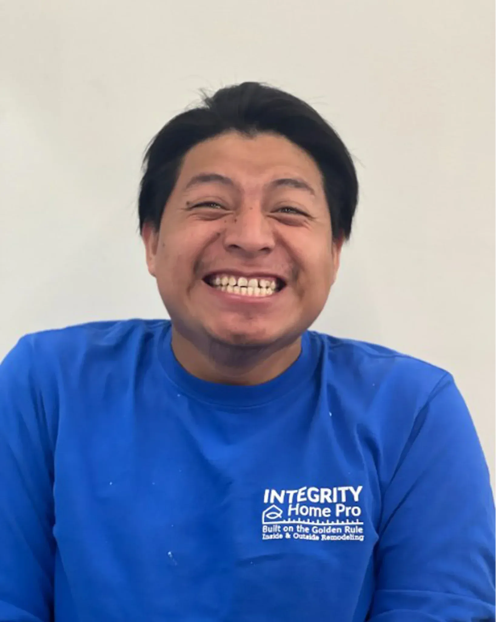 A headshot of a team member in a blue Integrity Home Pro t-shirt.