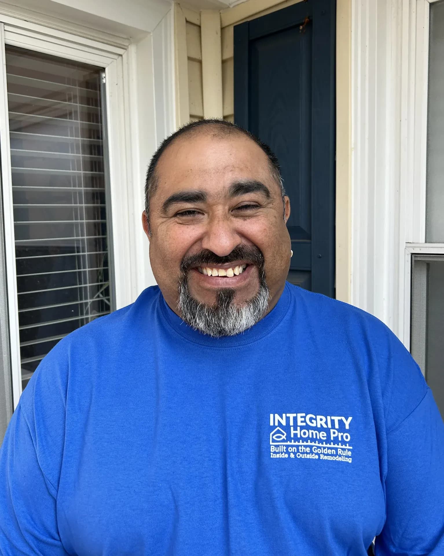 A headshot of a team member in a blue Integrity Home Pro t-shirt.