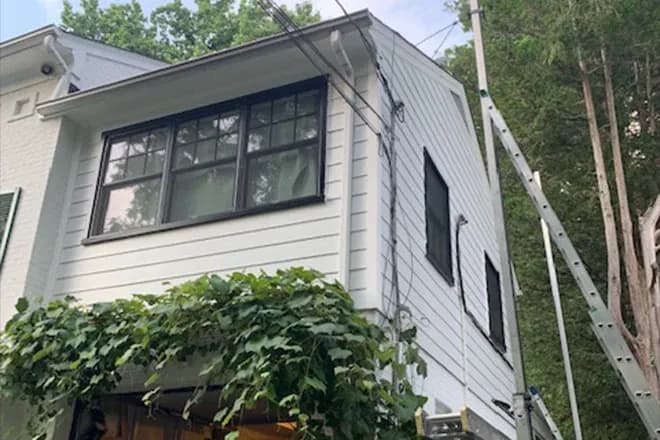 White horizontal fiber cement siding home addition above garage - Integrity Home Pro